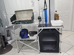 Folding Cooking Table Outdoor Portable Cook Station Aluminum Camping Kitchen with Storage Organizer, Windscreen, Hooks for BBQ, Party (Black)