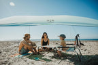 Neso Beach Table - Lightweight, Portable and Foldable Table for Beach, Camping and Outdoor Adventures - Stable Surface - with Cup Holder for Drinks and Phone Pockets - Rainbow